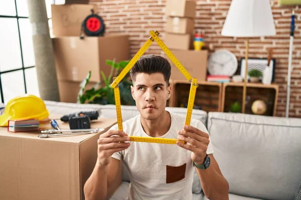 Young Hispanic Man Moving New Home Making Fish Face Mouth — Stockfoto