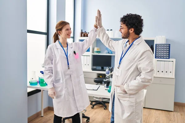 Man Woman Scientist Partners High Five Hands Raised Laboratory — стоковое фото