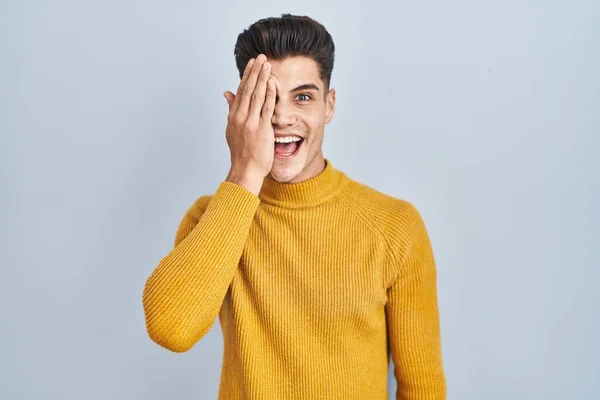 Young Hispanic Man Standing Blue Background Covering One Eye Hand — Foto de Stock