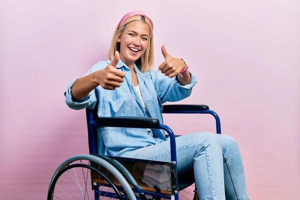 Beautiful Blonde Woman Sitting Wheelchair Approving Doing Positive Gesture Hand — Stockfoto