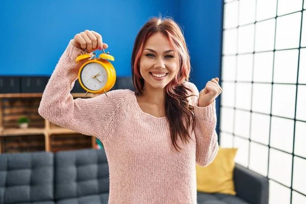 Young Caucasian Woman Holding Alarm Clock Screaming Proud Celebrating Victory — Stock Fotó
