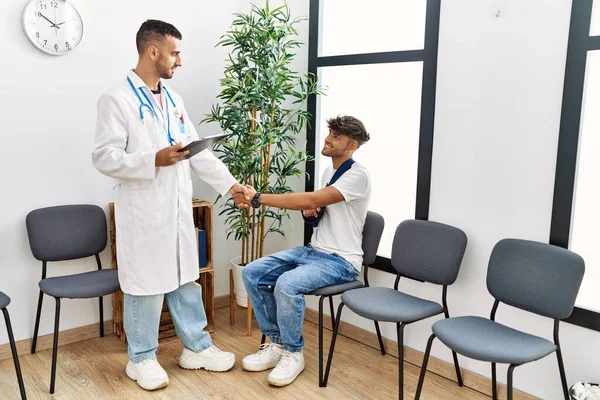 Двоє Іспаномовних Чоловіків Лікар Пацієнт Тремтять Руками Залі Очікування Госпіталю — стокове фото