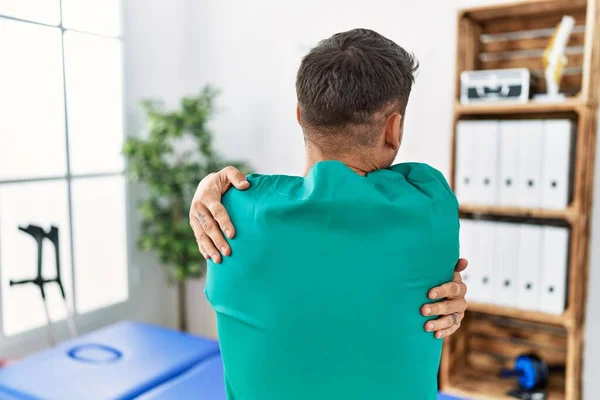 Young Physiotherapist Man Working Pain Recovery Clinic Hugging Oneself Happy — Stockfoto
