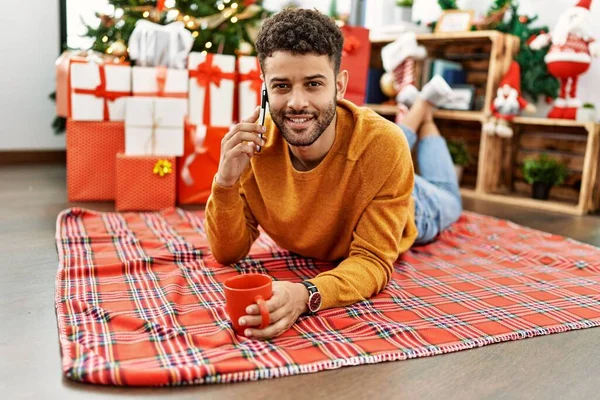 Young Arab Man Talking Smartphone Drinking Coffee Lying Floor Christmas — Foto de Stock