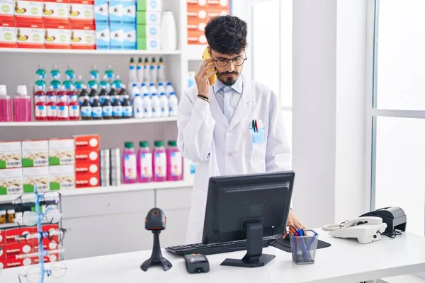 Young Hispanic Man Pharmacist Talking Smartphone Working Pharmacy — 图库照片