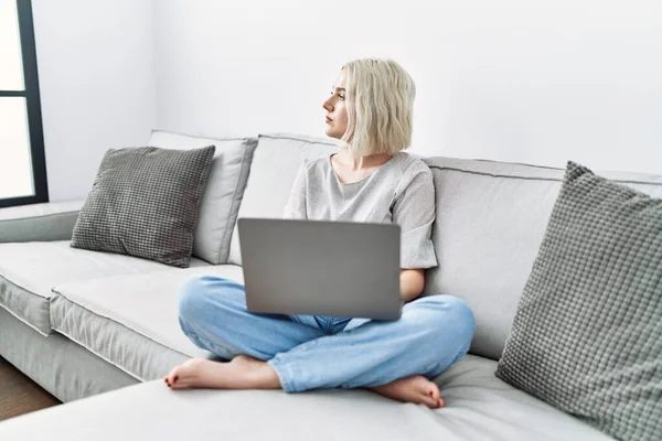 Young Caucasian Woman Using Laptop Home Sitting Sofa Looking Side — Stockfoto