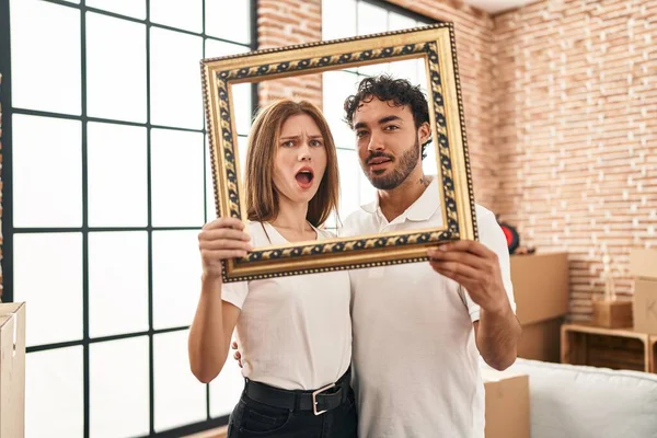 Young Two People Holding Empty Frame Together Shock Face Looking — Stockfoto
