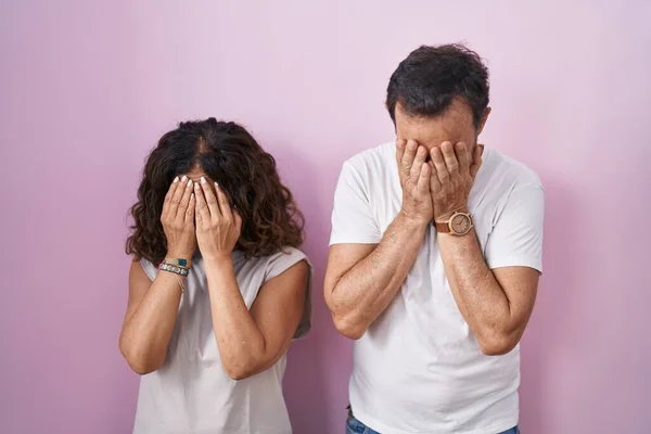 Middle Age Hispanic Couple Together Pink Background Sad Expression Covering — Stockfoto