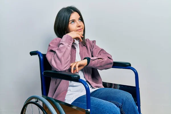 Young Brunette Woman Sitting Wheelchair Hand Chin Thinking Question Pensive — Foto de Stock