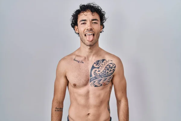 Hispanic Man Standing Shirtless Sticking Tongue Out Happy Funny Expression — Stockfoto