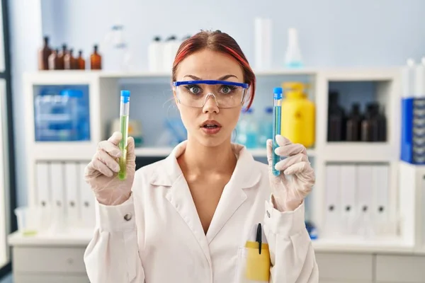 Young Caucasian Woman Working Scientist Laboratory Holding Samples Shock Face — Foto de Stock