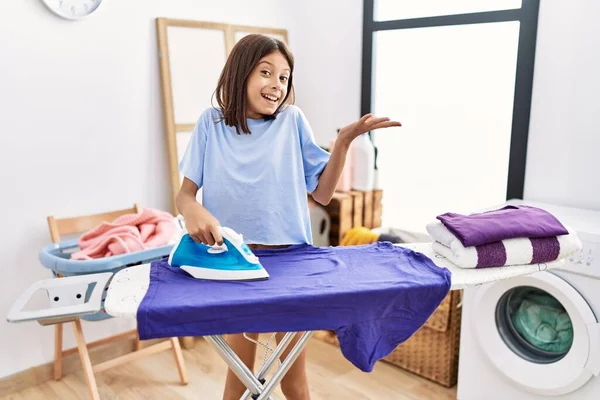 Young Hispanic Girl Ironing Clothes Laundry Room Celebrating Achievement Happy — Zdjęcie stockowe