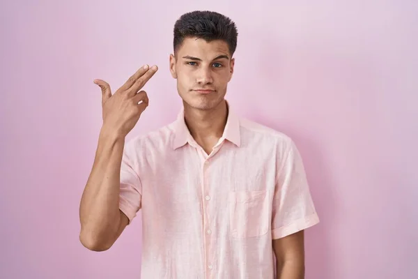 Young Hispanic Man Standing Pink Background Shooting Killing Oneself Pointing — Stock fotografie