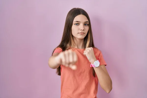 Teenager Girl Standing Pink Background Punching Fist Fight Aggressive Angry — Stock Fotó