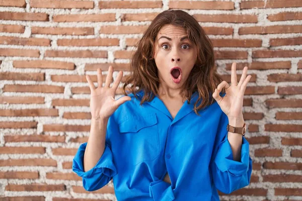 Beautiful Brunette Woman Standing Bricks Wall Looking Surprised Shocked Doing — Foto Stock