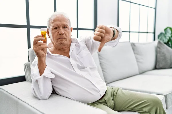 Senior Man Holding Pills Looking Unhappy Angry Showing Rejection Negative — Stock fotografie