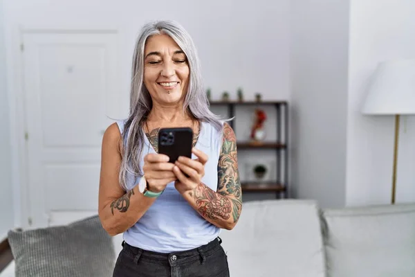 Grauhaarige Frau Mittleren Alters Lächelt Selbstbewusst Mit Smartphone Hause — Stockfoto