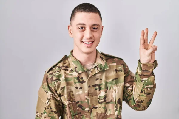Jovem Vestindo Uniforme Exército Camuflagem Mostrando Apontando Para Cima Com — Fotografia de Stock