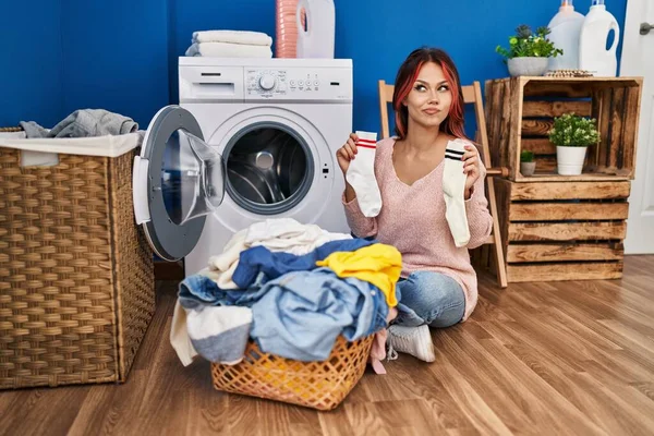 Young Caucasian Woman Doing Laundry Holding Socks Smiling Looking Side — ストック写真
