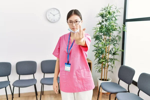 Young Asian Nurse Woman Medical Waiting Room Showing Middle Finger — стоковое фото