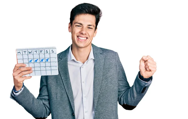 Young Hispanic Business Man Holding Travel Calendar Screaming Proud Celebrating — Stock Fotó