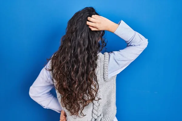 Mujer Morena Joven Pie Sobre Fondo Azul Hacia Atrás Pensando —  Fotos de Stock