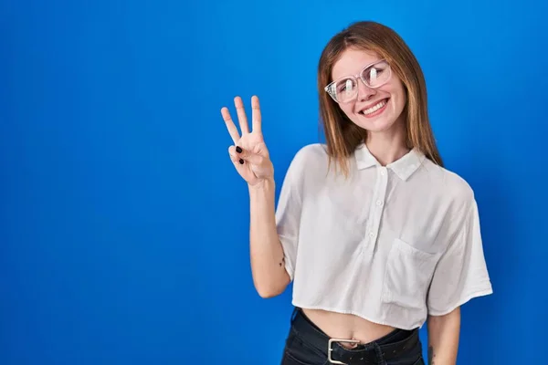 Beautiful Woman Standing Blue Background Showing Pointing Fingers Number Three — Foto de Stock