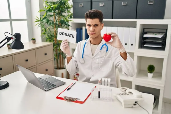 Young Hispanic Doctor Man Supporting Organs Donations Skeptic Nervous Frowning — 图库照片