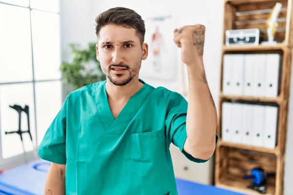 Young Physiotherapist Man Working Pain Recovery Clinic Angry Mad Raising — Stockfoto