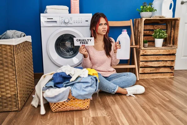 Young Caucasian Woman Doing Laundry Holding Cruelty Free Detergent Bottle — Stockfoto