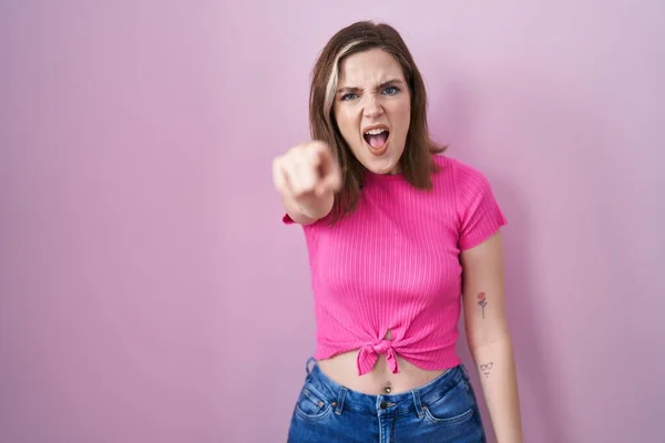 Blonde Caucasian Woman Standing Pink Background Pointing Displeased Frustrated Camera — стоковое фото