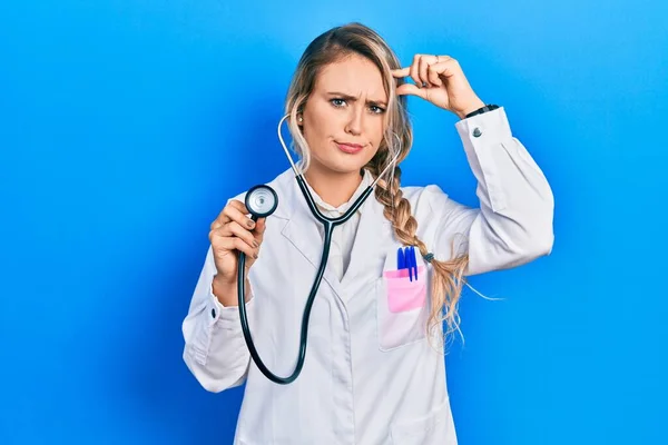 Beautiful Young Blonde Doctor Woman Holding Stethoscope Worried Stressed Problem — Stok fotoğraf