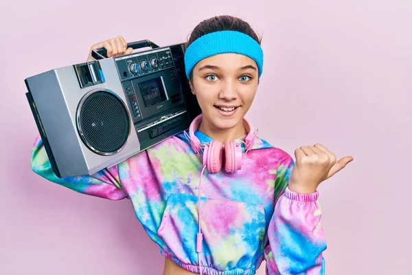 Young Brunette Girl Wearing Workout Clothes Holding Boombox Pointing Thumb —  Fotos de Stock