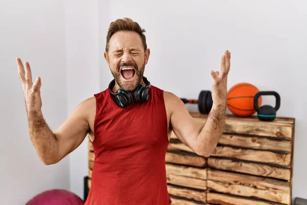 Middle Age Man Wearing Sportswear Headphones Gym Celebrating Mad Crazy — Stock Fotó