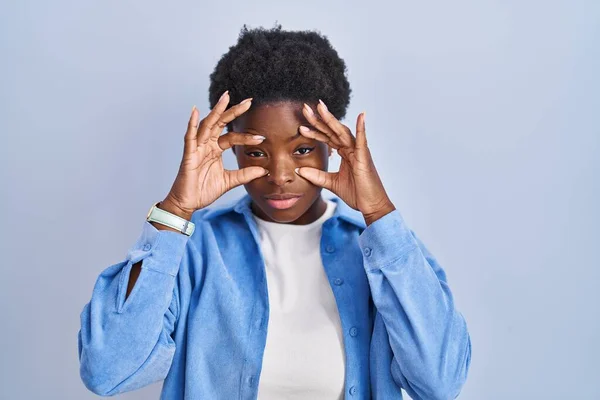 African American Woman Standing Blue Background Trying Open Eyes Fingers — Fotografia de Stock