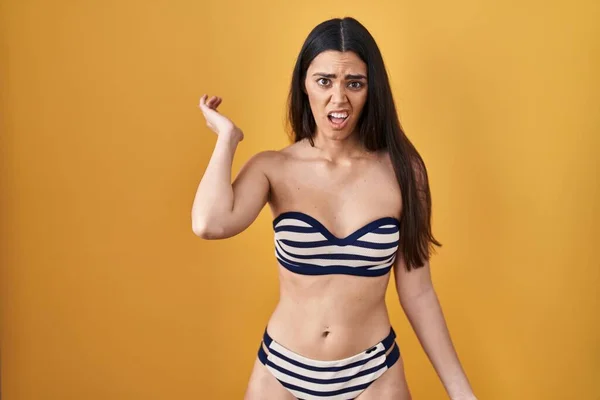 Young Brunette Woman Wearing Bikini Yellow Background Shock Face Looking — Φωτογραφία Αρχείου