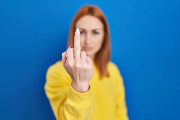 Young Woman Standing Blue Background Showing Middle Finger Impolite Rude — Stock fotografie