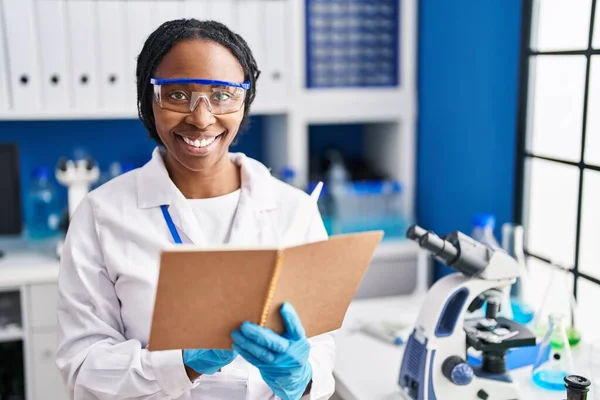 African American Woman Wearing Scientist Uniform Reading Book Laboratory — Stockfoto