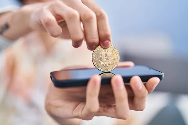 Young Hispanic Man Inserting Bitcoin Smartphone Home — Stockfoto