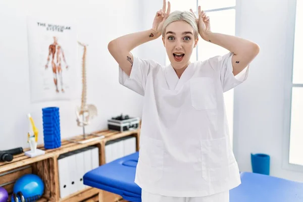 Young Caucasian Woman Working Pain Recovery Clinic Posing Funny Crazy — Stockfoto