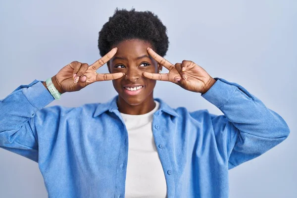 African American Woman Standing Blue Background Doing Peace Symbol Fingers — Stock fotografie
