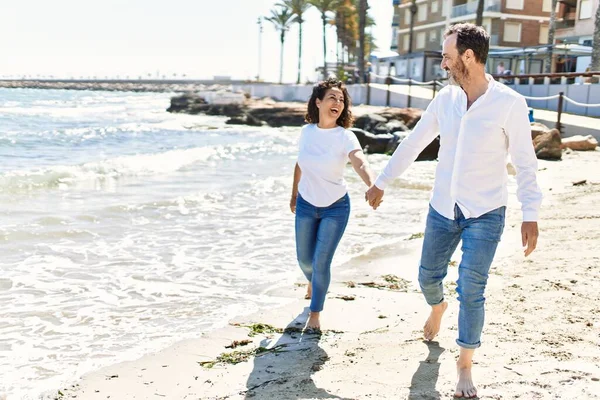 Middle Age Hispanic Couple Smiling Happy Walking Hands Together Beach — Stock fotografie