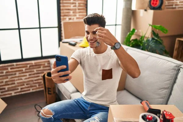 Young Hispanic Man Having Video Call Holding Key House New — Zdjęcie stockowe