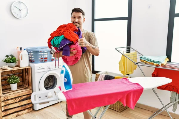 Young Handsome Man Holding Laundry Ready Iron Smiling Happy Positive — Stok fotoğraf