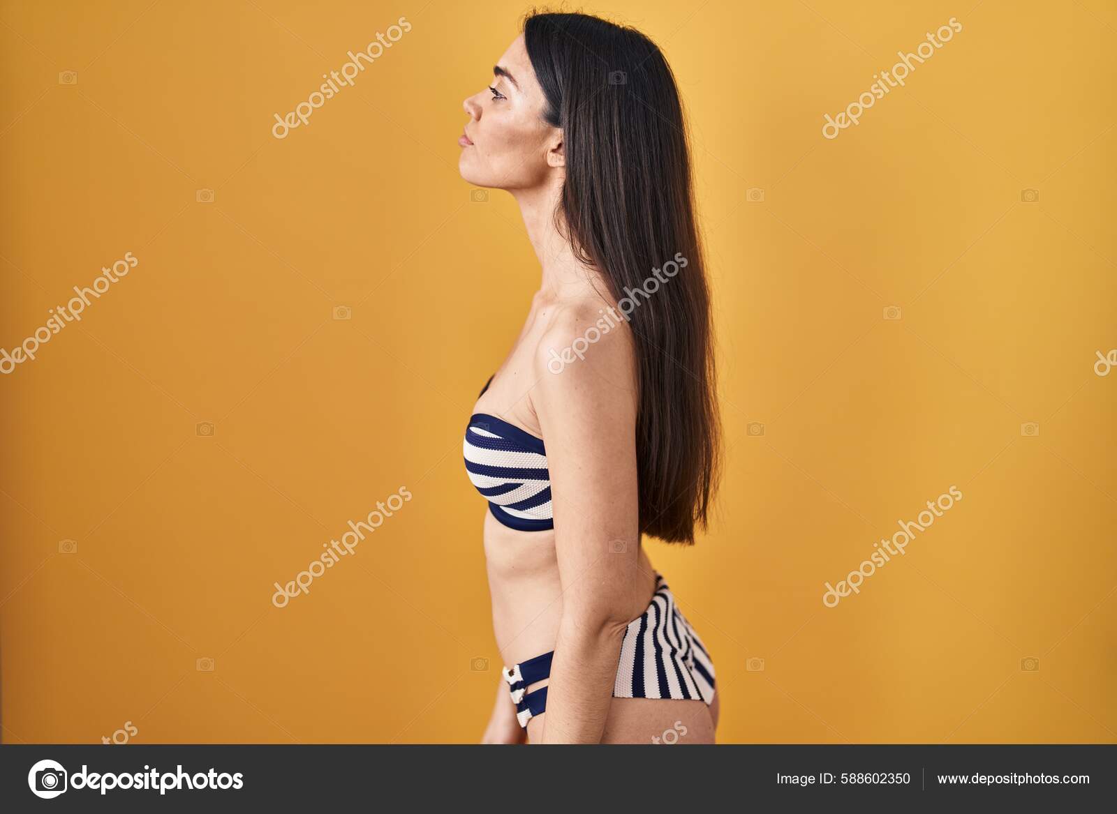 Young Brunette Woman Wearing Bikini Yellow Background Looking Side.