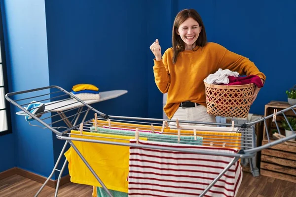 Young Brunette Woman Hanging Clothes Clothesline Screaming Proud Celebrating Victory — Stock Photo, Image