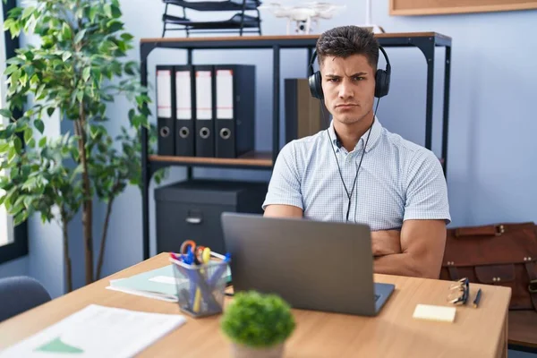 Young Hispanic Man Working Office Wearing Headphones Skeptic Nervous Disapproving — Foto Stock