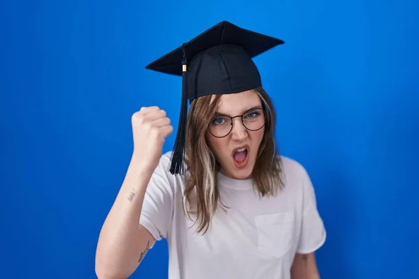 Blonde Caucasian Woman Wearing Graduation Cap Angry Mad Raising Fist — Stockfoto