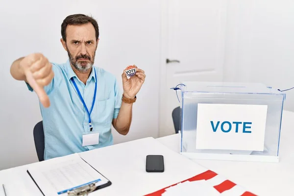 Middle Age Man Beard Sitting Ballot Holding Vote Badge Looking — Zdjęcie stockowe