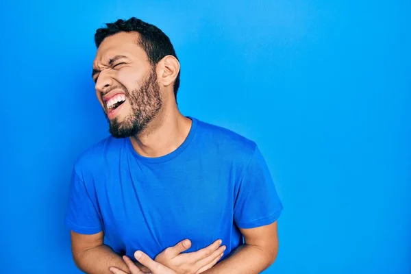 Hispanic Man Beard Wearing Casual Blue Shirt Hand Stomach Because — Stockfoto